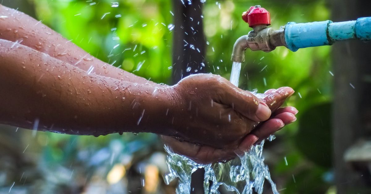 Hands and running water