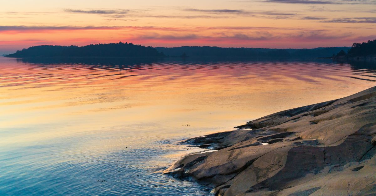 Rocky shoreline and Baltic sea at sunset.