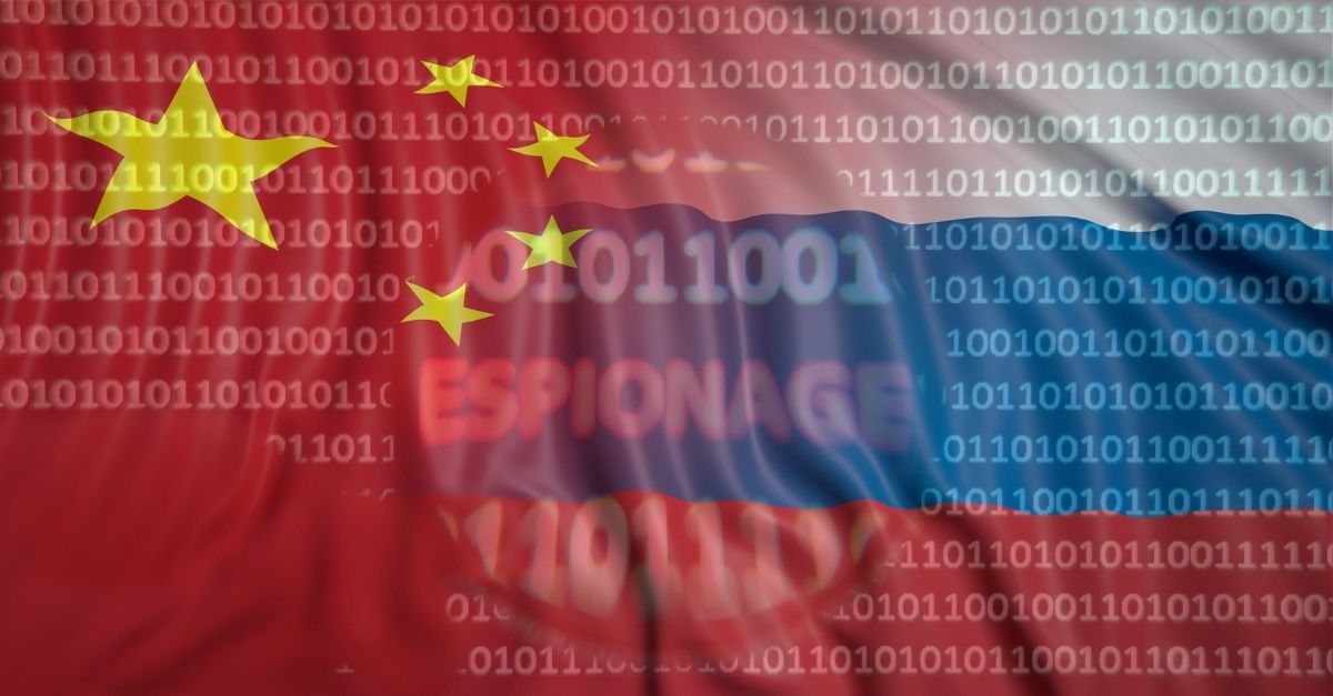 A digitally stylized image of the Chinese flag and Russian flag overlaid with binary code and the words “espionage”.