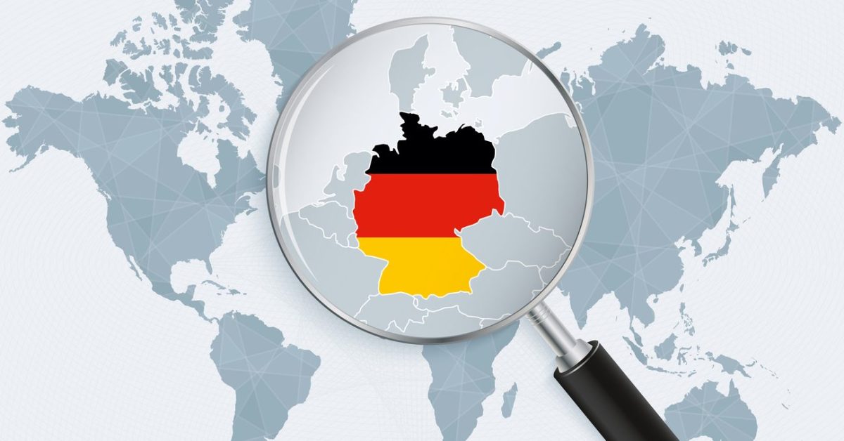 World map with a magnifying glass pointing at Germany. Map of Germany with the flag in the loop.