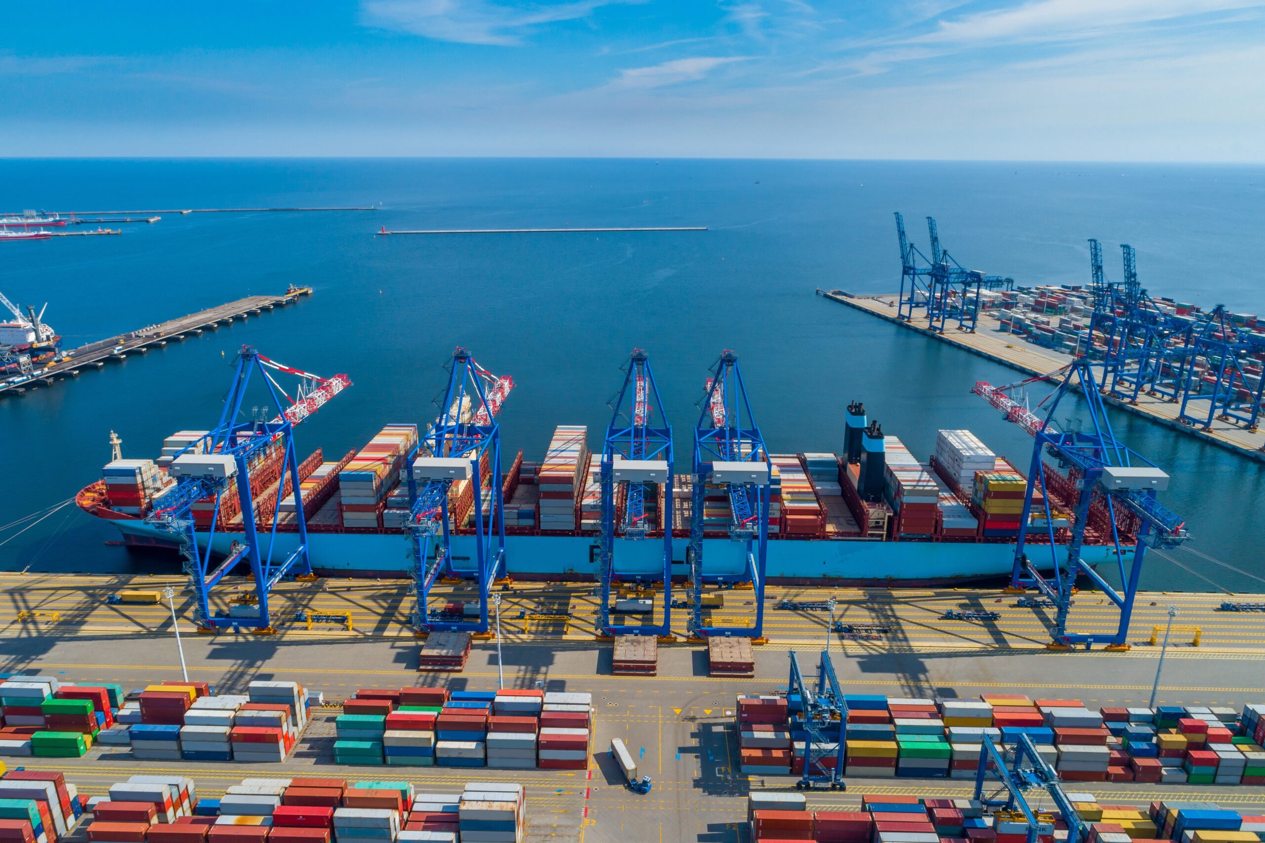 Port environment in the Port of Gdynia with a cargo ship and containers.