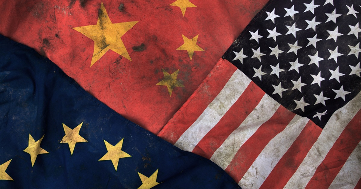 Low key photography of dirty flags of China, United States of America (USA) and United Europe (UE).