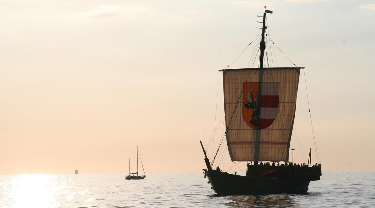 Viking style ship sailing in sunset