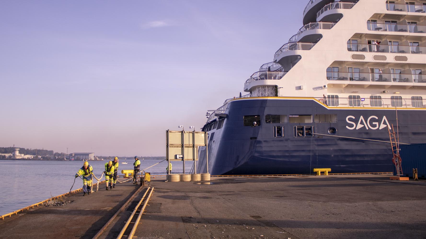 Port workers are securing a cruise ship to the quay at the Port of Pori, Finland.