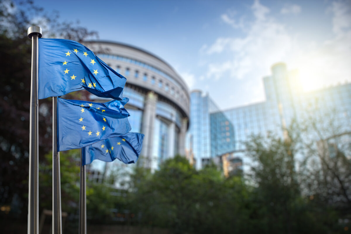 European Union flags against EU parliament building in Brussels, Belgium.