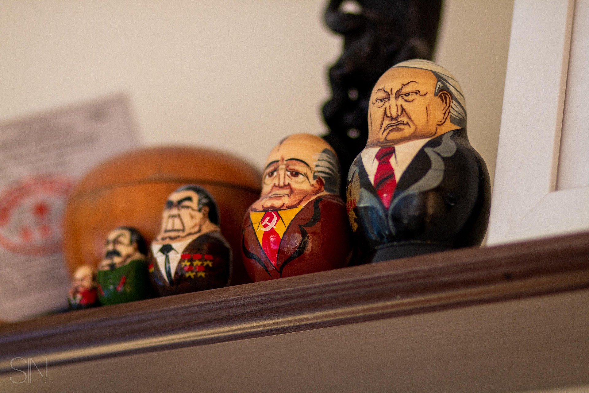 Matryoshka dolls depicting Soviet political leaders, arranged from smallest to largest on a shelf.